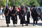  Graduates walk outside the Spring Convocation ceremony