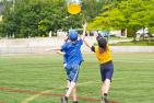 children chase a disc on a turf field