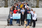Group of people holding a sign promoting the Terry Fox Run 