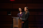 Two students speaking at a podium. 