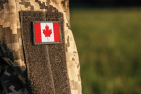 Canadian flag arm patch on camo jacket