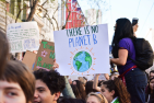 Activists at a street rally with protest signs.