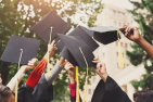 Graduate caps being raised in the air