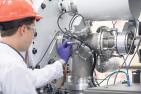 Researcher observes machinery at RMTL