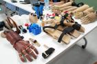 3D-printed prosthetics displayed on a white folding table