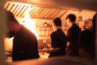 Three chefs cooking with fire in kitchen.