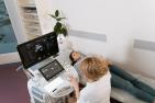 Woman getting an ultrasound on her stomach by doctor.