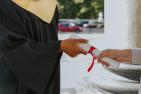 Close up of exchange of diploma at graduation.