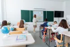 teacher and school kids in a classroom