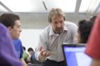 David strong with students at computer