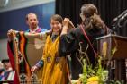 A graduate of the Engineering and Applied Science class being presented with a Pendleton blanket. (Queen's University/Garrett Elliott)