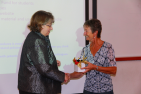 Joan Almost receives a token of appreciation for her efforts as a graduate coordinator.