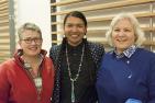 James Makokis (centre) standing with lecture series supporters M. Nancy Tatham (left) & Donna Henderson (right).
