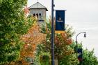 Photograph of a Queen's pennant in front of Grant Hall.
