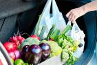 Photo of groceries being loaded into a car.