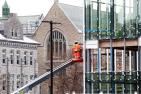 Workers continue to install glass panels on the south side of the Innovation and Wellness Centre. (Photo by Bernard Clark)