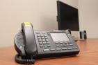 [Telephone on desk]