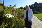 Isabel Bader examines the plaque at the Alfred and Isabel Bader Tricolour Garden