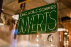 Ouverts sign in green with white lettering
