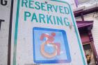 [International Symbol of Access on a reserved parking sign]