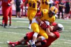 "A Queen's Gaels football plyer is tackled by a member of the Carleton Ravens"