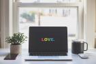 "Love" written in rainbow font on a laptop screen.