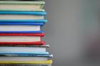 Stack of books (Photo by Kimberly Farmer, via Unsplash)