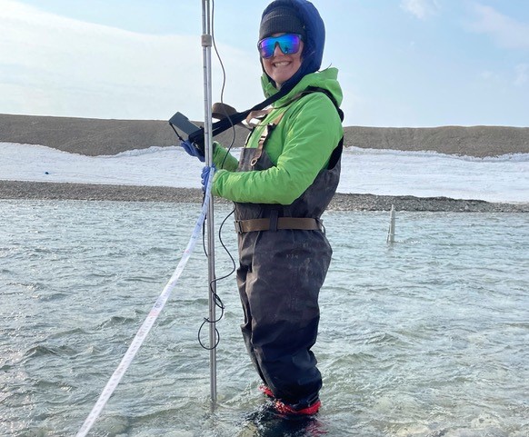 Researcher taking wetland readings with equipment