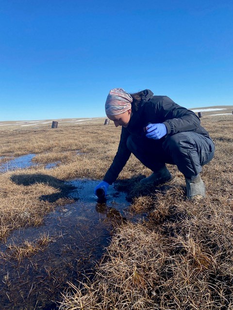 Researcher collecting water sample