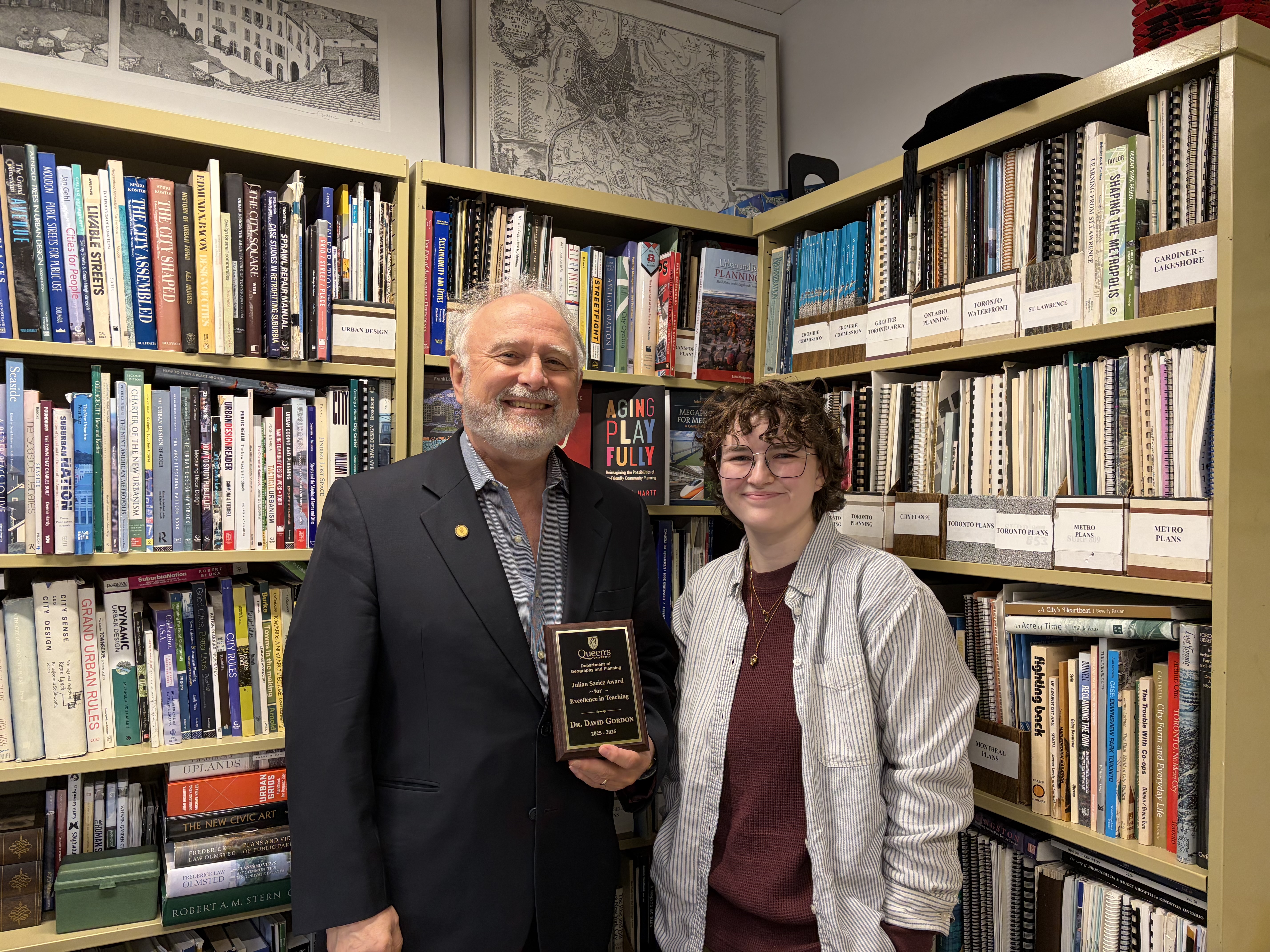 Dr. Dave Gordon (left) is presented with the Julian Szeicz Award for Teaching Excellence by Geography DSC Co-President Chloe Moses (right)