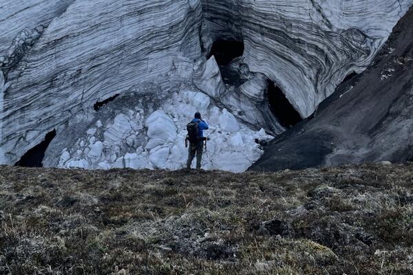 Student hiking at base of glacier