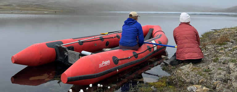 students on boat pulled up to shore