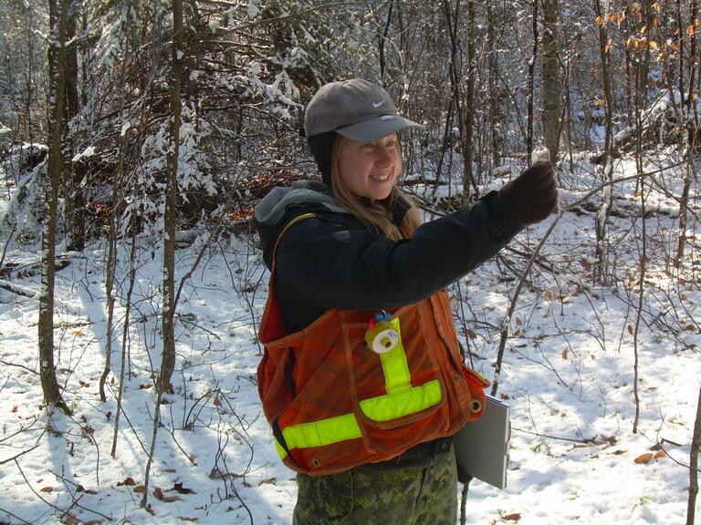 student measuring in the field in the winter