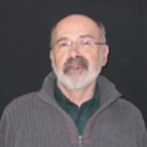 [Photo of Dr. J. Barry Riddell]