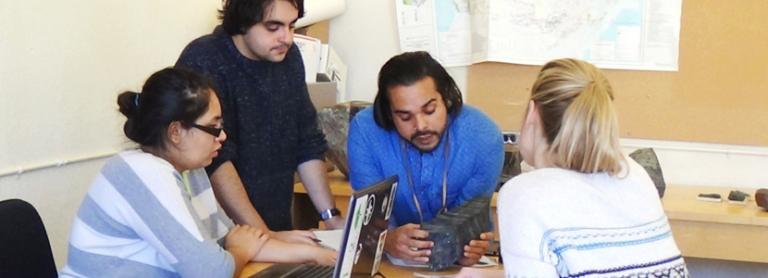 Geological Sciences and Geological Engineering students examining a sample