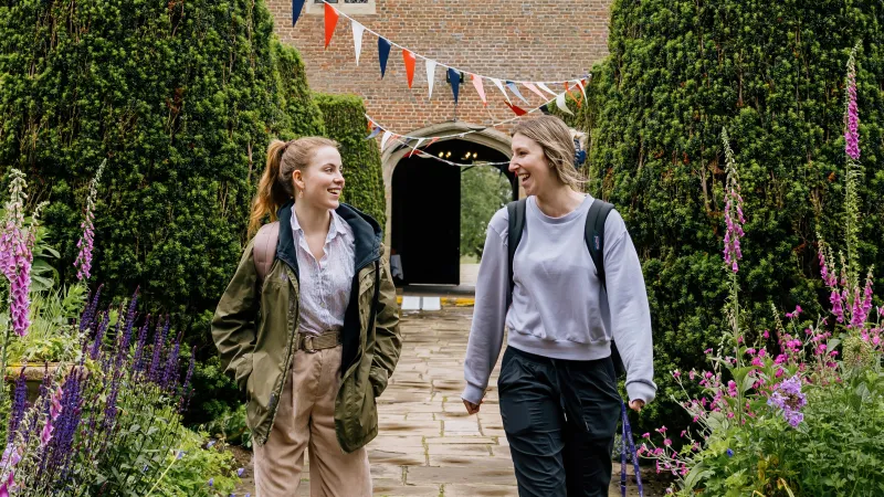 Two students are walking and chatting