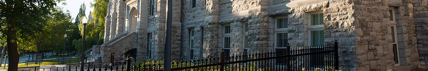 Street view of campus, showing the side of Queen's University buildings.