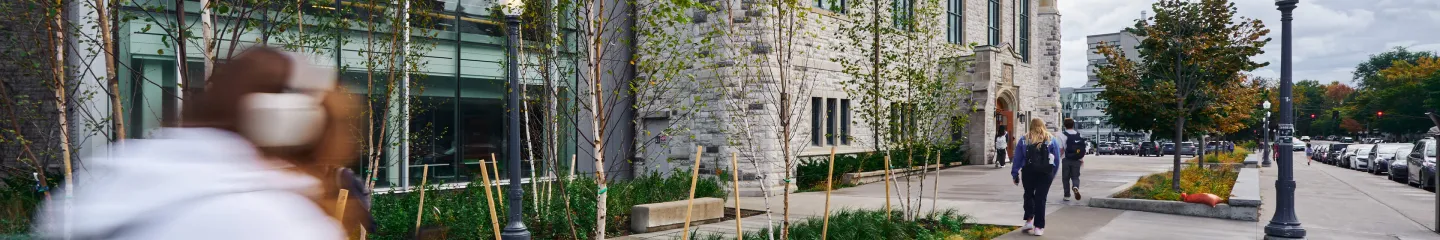 Street view of the Queen's campus, showing students walking around.