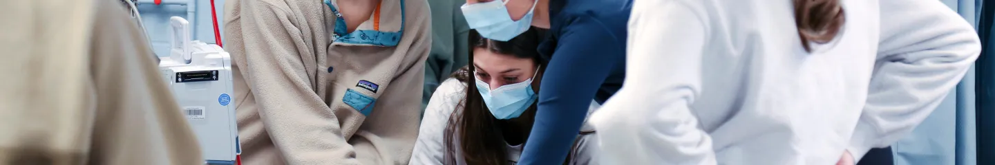 School of Nursing students in a hospital setting wearing facemasks. 