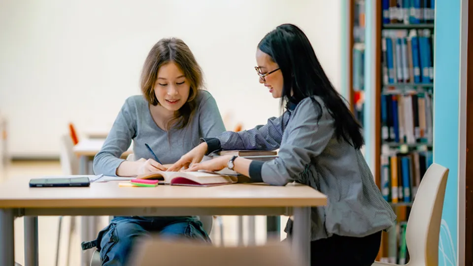 Photo of two students are studying together
