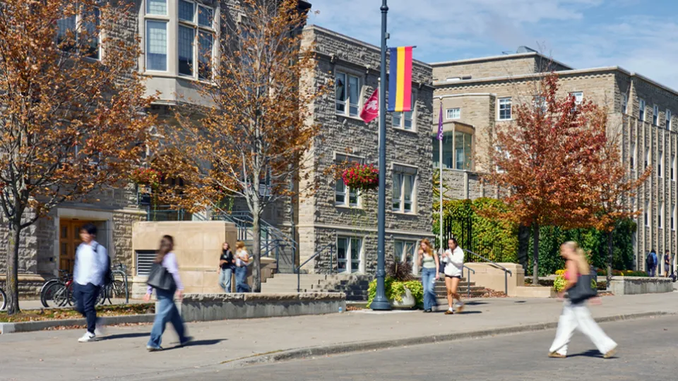 Street view of campus, with students walking around. 