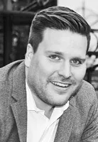 Black and white photo of Rory MacDonald smiling, commemorating the establishment of his Memorial Bursary.