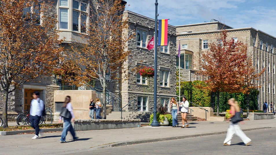 Street view of campus, with students walking around. 