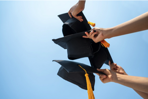 Graduation caps against a clear sky