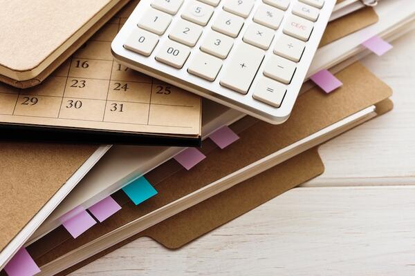 a file folder, calendar and calculator