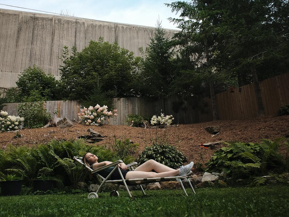 Two young girls are in the pool together. The artful shot shows them both above and below the water