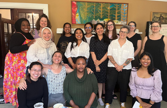 The image shows fifteen mature women gathered indoors at the Ban Righ Centre.
