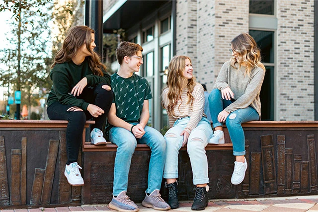 A group of teenagers talking outside