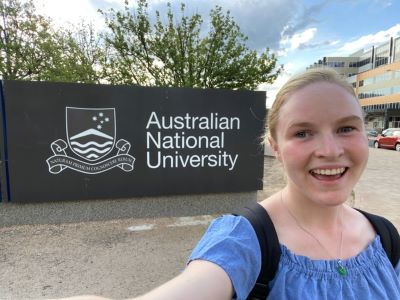 Image of Victoria Opreff in front of the Australia National University sign
