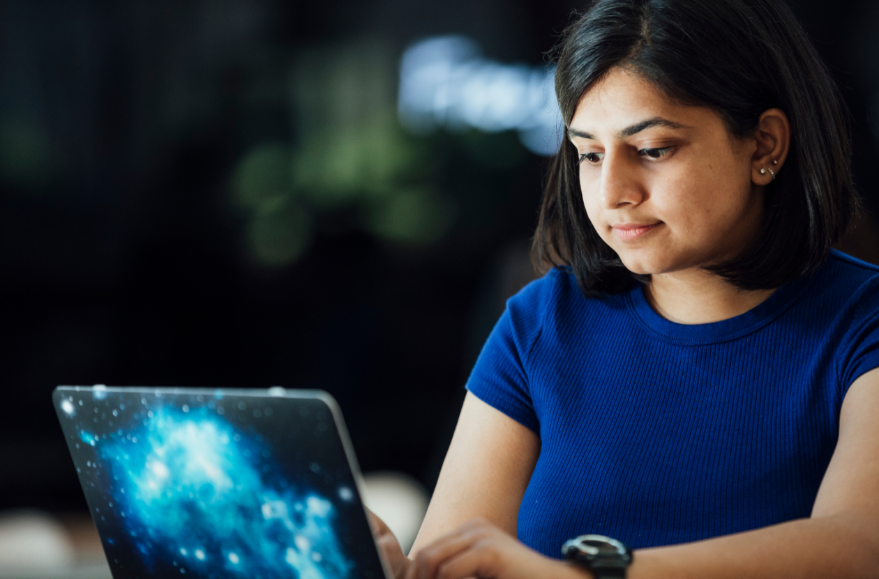 An Image of a student working at her laptop. 